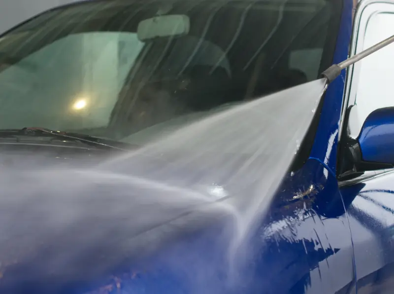 spray waxing car at car wash