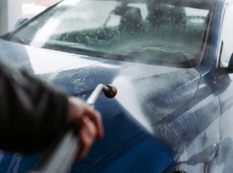 many spray washing car with soap